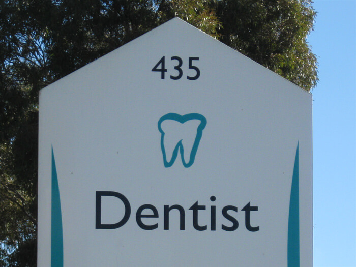 An extracted healthy tooth with roots - dentist logo.